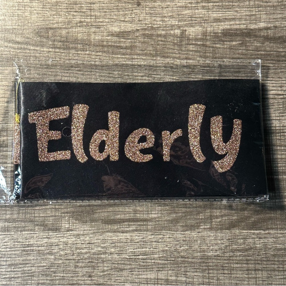 “Elderly & Awesome” Sash Black With Pink/rose Gold Letters
